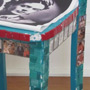 A chair with mosaic tiles, picture tiles featuring images of Frida Kahlo and her paintings