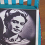A chair with mosaic tiles, picture tiles featuring images of Frida Kahlo and her paintings